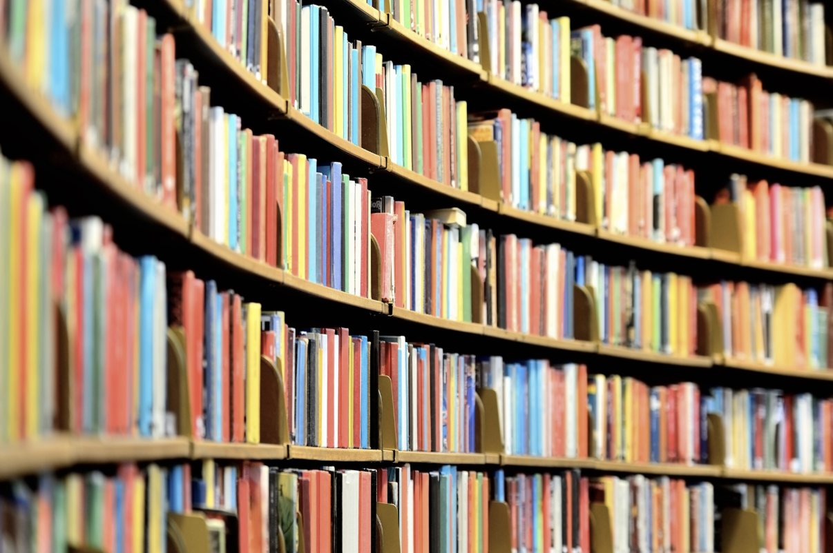 Curved library shelves filled with colorful books