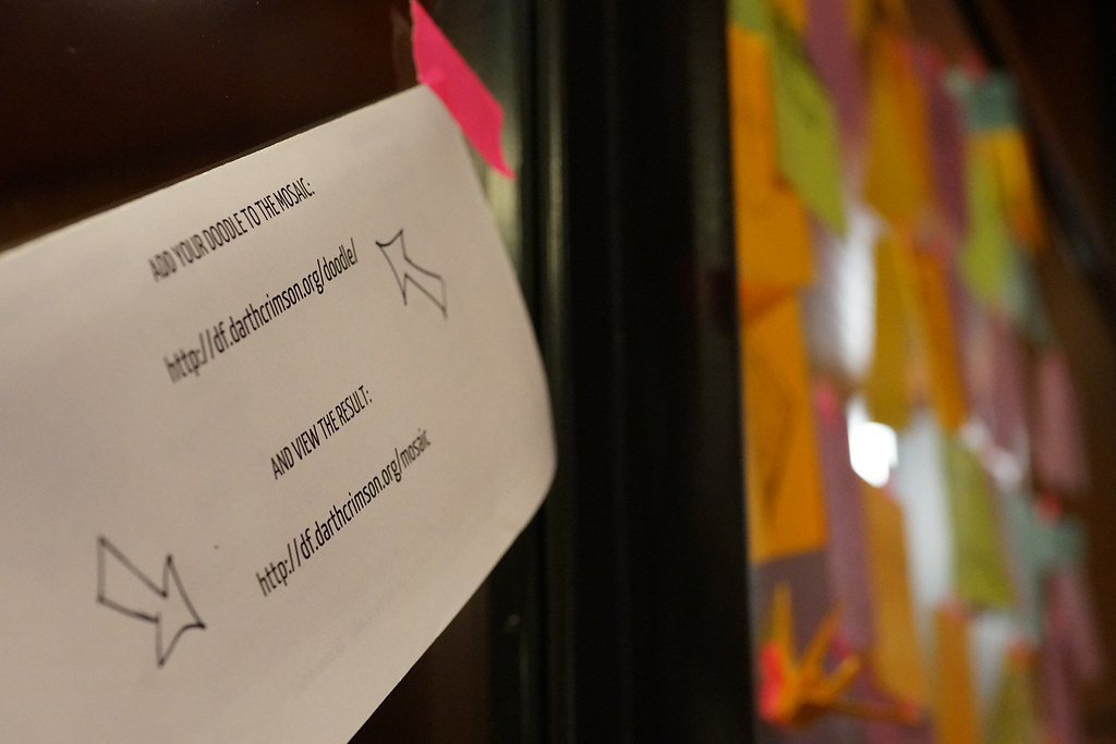 A table stocked with markers and paper at the doodle center, inviting attendees to sketch their ideas.
