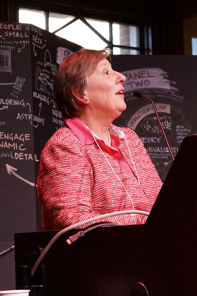 Sarah Thomas of the Harvard Library addresses the symposium from the stage.