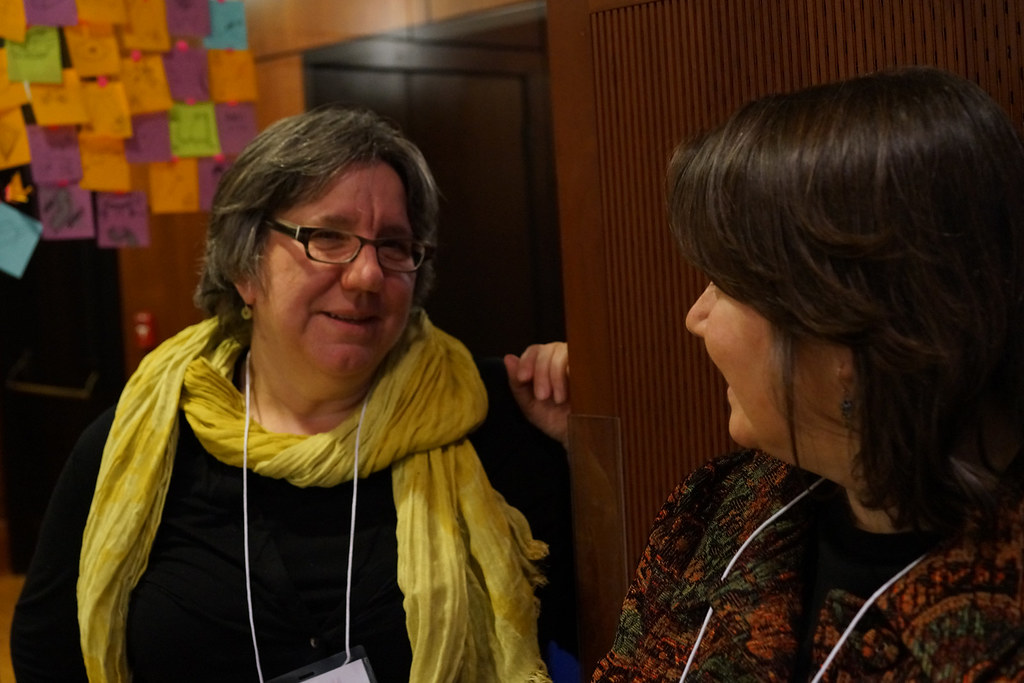 Two attendees, both named Susan, laughing as they compare notes between sessions.
